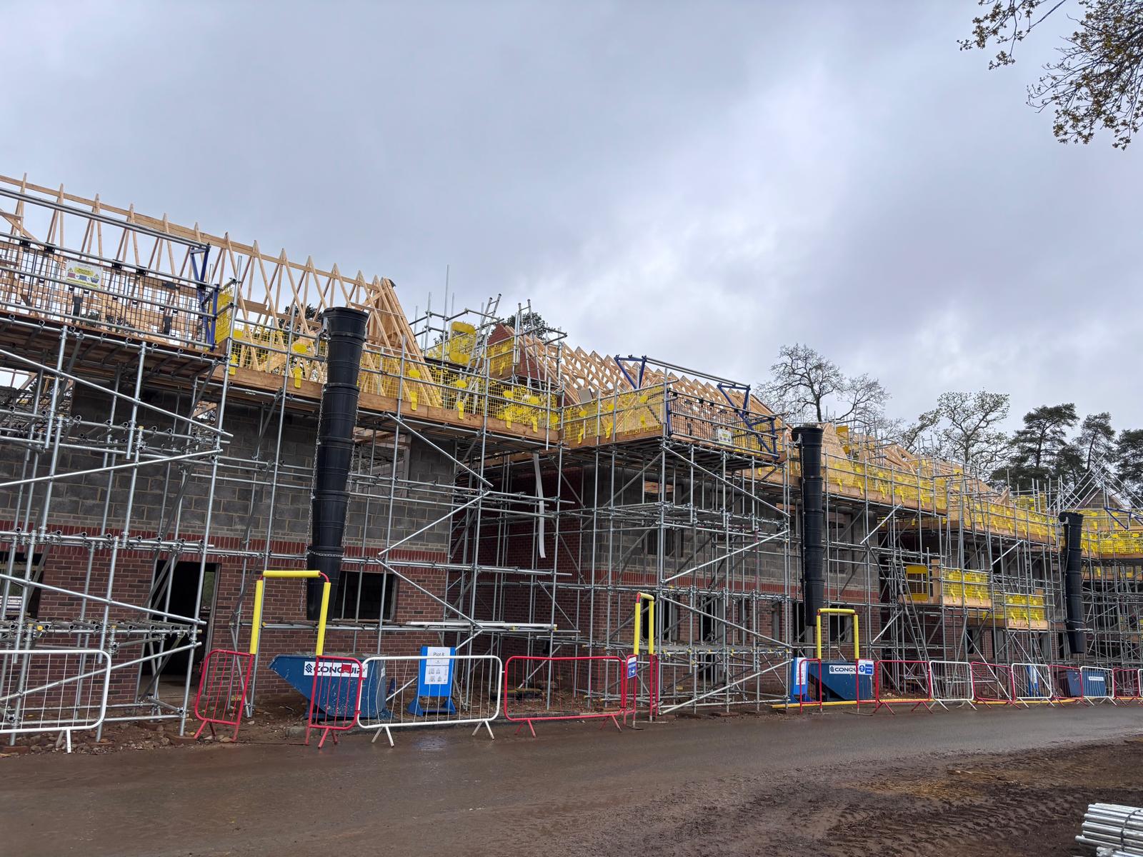 GoulPar scaffolding wrapping a large mid-build residential terrace, roof trusses going on under Rhino decking