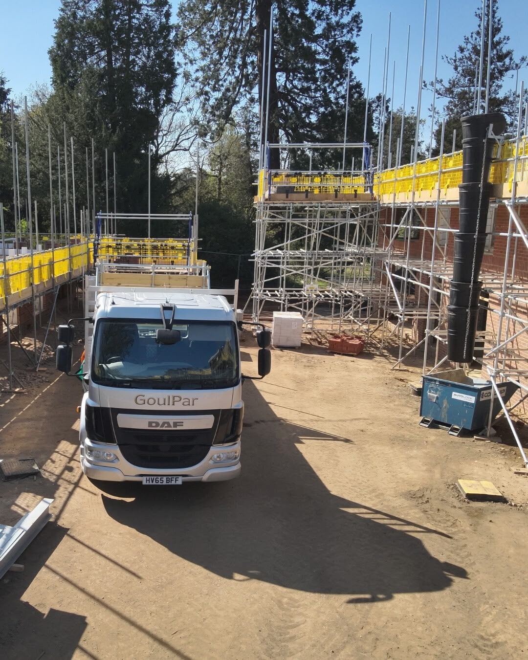 GoulPar branded DAF lorry on site, scaffold and Rhino decking erected behind — own yard, own equipment